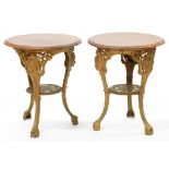 A PAIR OF CAST IRON PUB TABLES, THE THREE ORNATE LEGS HEADED BY FEMALE MASKS, UNDER TIER INSCRIBED