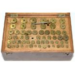 A VICTORIAN DEAL BOXED SET OF BRASS TURNING FERRULES