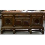 A CARVED AND DARK STAINED OAK SIDEBOARD, 184CM W, EARLY 20TH C