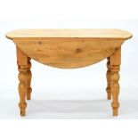 A WAXED PINE DROP LEAF DINING TABLE