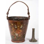 A LEATHER FIRE BUCKET WITH COLOURED TRANSFERED ROYAL ARMS, IRON RINGS AND LEATHER HANDLE, 34CM H