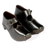 A PAIR OF EARLY 20TH C LANCASHIRE CARVED WOOD, BLACK LEATHER AND IRON SHOD CHILD'S CLOGS, 14.5CM L