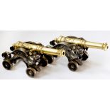 A PAIR OF BRASS MODEL CANNON ON CAST IRON GRIFFIN CARRIAGES, 46CM L