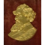 [DICKENS, CHARLES] A 19TH CENTURY FRAMED GILT-METAL PORTRAIT OF DICKENS In high relief, facing left,