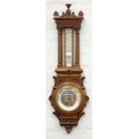 AN EDWARDIAN CARVED OAK ANEROID BAROMETER, WITH MERCURY THERMOMETER, 88CM H, C1910