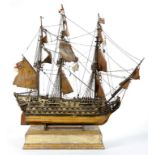 A PAINTED WOOD AND METAL MODEL OF AN 18TH C ROYAL NAVY FRIGATE, WITH MASTS, RIGGING AND SAILS, ON