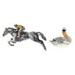 A POLYCHROME DECORATED SILVER HORSE AND JOCKEY BROOCH AND A SILVER AND ENAMEL MINIATURE MODEL OF A