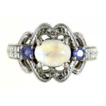 A MOONSTONE AND TANZANITE THREE STONE RING IN 14CT WHITE GOLD, 5.4G, SIZE M