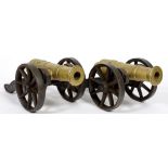 A PAIR OF MODELS OF BRASS CANNON ON CAST IRON CARRIAGES, 34CM L OVERALL