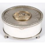 AN ELIZABETH II NEO CLASSICAL STYLE OVAL PARCEL GILT SILVER MUSICAL BOX ON FOUR PAW FEET, LONDON