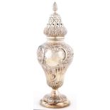 AN ORNATE EDWARD VII EMBOSSED SILVER CASTER AND COVER OF FLUTED OGEE SHAPE, 24CM H, BIRMINGHAM 1907,