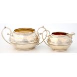 A COMPRESSED GLOBULAR SILVER CREAM JUG AND SUGAR BOWL WITH SCROLL HANDLES, 6 AND 7CM H, LONDON