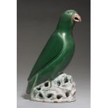 A CHINESE GREEN AND AUBERGINE GLAZED MODEL OF A PARROT PERCHED ON A ROCK, 19TH/20TH C with