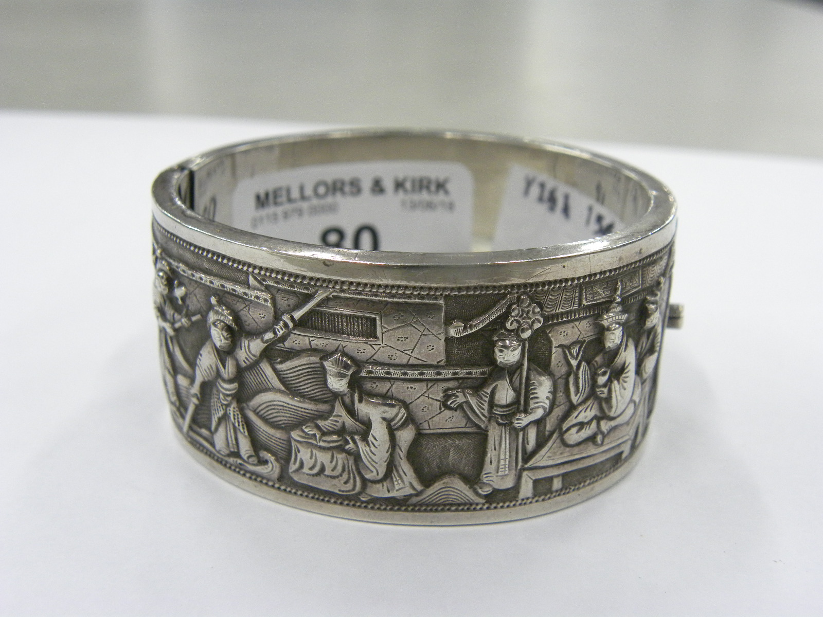 A CHINESE EXPORT SILVER REPOUSSE BANGLE, C1900 decorated to either side with groups of figures, 57 x - Image 3 of 5