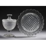 AN ENGLISH CUT GLASS PEDESTAL SWEETMEAT JAR AND COVER AND A CUT GLASS DISH OR STAND, BOTH LATE
