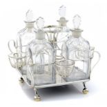 A SHEFFIELD PLATE WIREWORK LIQUOR WAGON AND FOUR CONTEMPORARY FACETED GLASS DECANTERS AND
