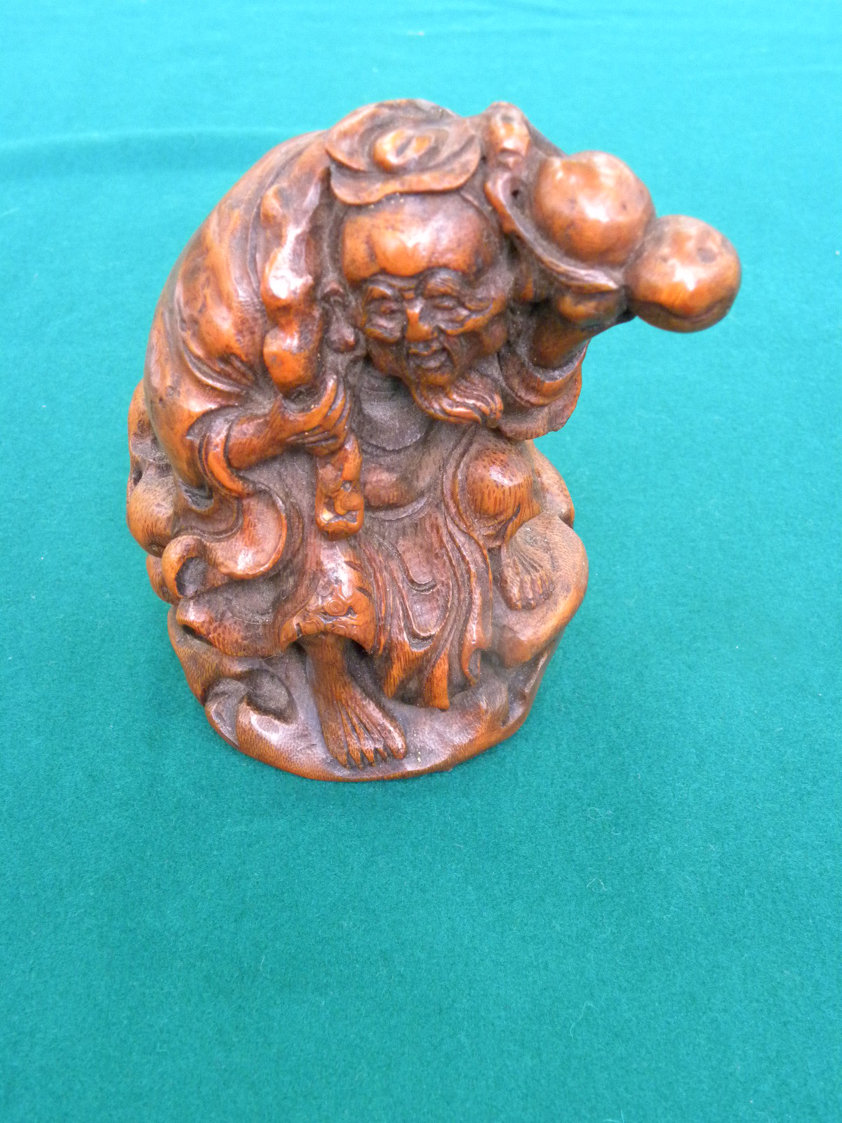 A CHINESE CARVED BAMBOO FIGURE OF SHOU-LAO on a rock, holding a peach bough in his left hand and - Image 2 of 4