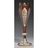 A BOHEMIAN OVERLAY GLASS VASE, C1860 in cranberry overlaid in white and painted with tapered