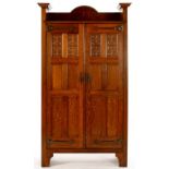 SHAPLAND AND PETTER. AN ARTS AND CRAFTS OAK HALL CUPBOARD, C1905, THE PAIR OF DOORS WITH 17TH C