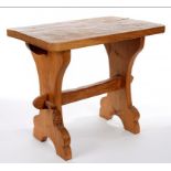 A THOMAS 'GNOMEMAN' WHITTAKER OAK OCCASIONAL TABLE, THE OBLONG ADZED TOP ON TRESTLES WITH PEGGED