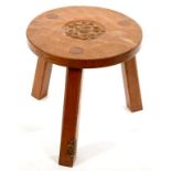 A THOMAS 'GNOMEMAN' WHITTAKER OAK OCCASIONAL TABLE, THE ROUND ADZED TOP CARVED WITH A ROSE, ON THREE