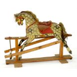 A PAINTED WOOD ROCKING HORSE, PROBABLY LINES BROTHERS, ON LIGHT WOOD STAND, 125CM L, SECOND