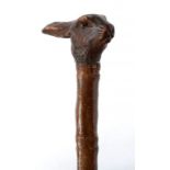 A BAMBOO WALKING STICK WITH CARVED SOFT WOOD HARE'S HEAD HANDLE, GLASS BEAD EYES, BRASS TIP, 96CM H,
