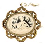 A CARVED BONE MEDALLION, DEPICTING A CHILD AND A SPANIEL, SET IN A CONTEMPORARY GOLD PLATED