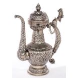 A TIBETAN PLATED AND REPOUSSE METAL DRAGON HANDLED TEAPOT WITH CHAINED LID, 36CM H, 20TH C