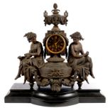 A FRENCH BRONZED METAL MANTEL CLOCK, THE MOVEMENT IN A PILLAR, SURMOUNTED BY THE TWO HANDLED URN AND