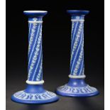 A PAIR OF WEDGWOOD BLUE JASPER DIP PILLAR CANDLESTICKS, C1870, with bands of spiralling foliage