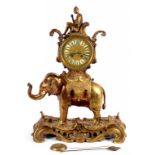 A FRENCH GILTMETAL MANTEL CLOCK IN LOUIS XV STYLE, THE DRUM CASED MOVEMENT SURMOUNTED BY THE