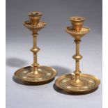 A PAIR OF VICTORIAN GILT BRASS AND CHAMPLEVE ENAMEL DESK CANDLESTICKS, C1870 with a design of