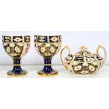 A PAIR OF ROYAL CROWN DERBY WITCHES PATTERN GOBLETS AND AN OVAL SUGAR BOX AND COVER, GOBLETS 12CM H,