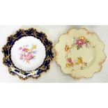 TWO ROYAL CROWN DERBY PLATES, ONE PAINTED WITH FLOWERS IN A LIGHTLY MOULDED COBALT AND RAISED GILT