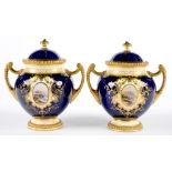 A PAIR OF COALPORT TWO HANDED GLOBULAR COBALT GROUND VASES AND COVERS, THE VASES PAINTED TO EITHER