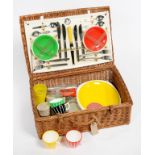 A 1960S BRIGHTLY COLOURED PLASTIC FITTED WICKER PICNIC BASKET, 50CM W