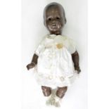 A GERMAN BISQUE HEADED BLACK BABY DOLL, THE HEAD WITH (DETACHED) SLEEPING EYES AND OPEN MOUTH WITH