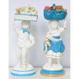 A PAIR OF WILLIAM BROWNFIELD TURQUOISE AND GILT FIGURES OF CHILDREN WITH BASKETS OF BRIGHTLY