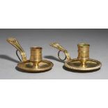 A PAIR OF LOUIS XV BRASS CANDLESTICKS, MID 18TH C with brass wire ring under the handle, 14cm l++