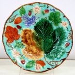 A WEDGWOOD MAJOLICA MOULDED DESSERT PLATE, DECORATED WITH LEAVES AND FRUIT ON A TURQUOISE GROUND,