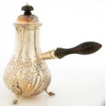 A VICTORIAN SILVER SIDE HANDLED AND LIDDED JUG, SPIRALLY REEDED AND EMBOSSED WITH PENDANT FLOWERS,