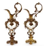 A PAIR OF FRENCH FIN DE SIECLE GILT BRASS AND SEMI OPALESCENT GLASS EWERS, APPLIED WITH MASKS OF A
