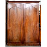 A VICTORIAN MAHOGANY WARDROBE WITH A PAIR OF PANELLED DOORS, THE INTERIOR FITTED WITH THREE