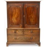 A GEORGE III MAHOGANY LINEN PRESS FITTED WITH PANELLED DOORS, THE INTERIOR FITTED WITH FOUR TRAYS,