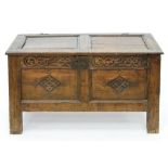 A CARVED OAK CHEST FITTED WITH PANELLED FRONT LID AND SIDES, EARLY 18TH C, 55CM H; 94 X 45CM