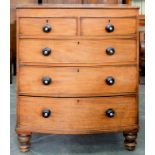 A VICTORIAN MAHOGANY BOW FRONTED CHEST OF DRAWERS WITH EBONISED KNOBS, ON TURNED FEET, 110CM H; 93 X