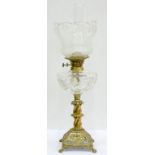 A VICTORIAN CAST BRASS OIL LAMP ON OPEN PYRAMIDALFOOT WITH CUT GLASS FOUNT, BRASS BURNER AND ETCHED