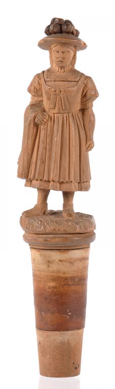 TREEN. A SWISS CARVED LIMEWOOD FIGURAL CORK STOPPER IN THE FORM OF A LITTLE GIRL, 12CM H OVERALL,