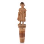 TREEN. A SWISS CARVED LIMEWOOD FIGURAL CORK STOPPER IN THE FORM OF A LITTLE GIRL, 12CM H OVERALL,
